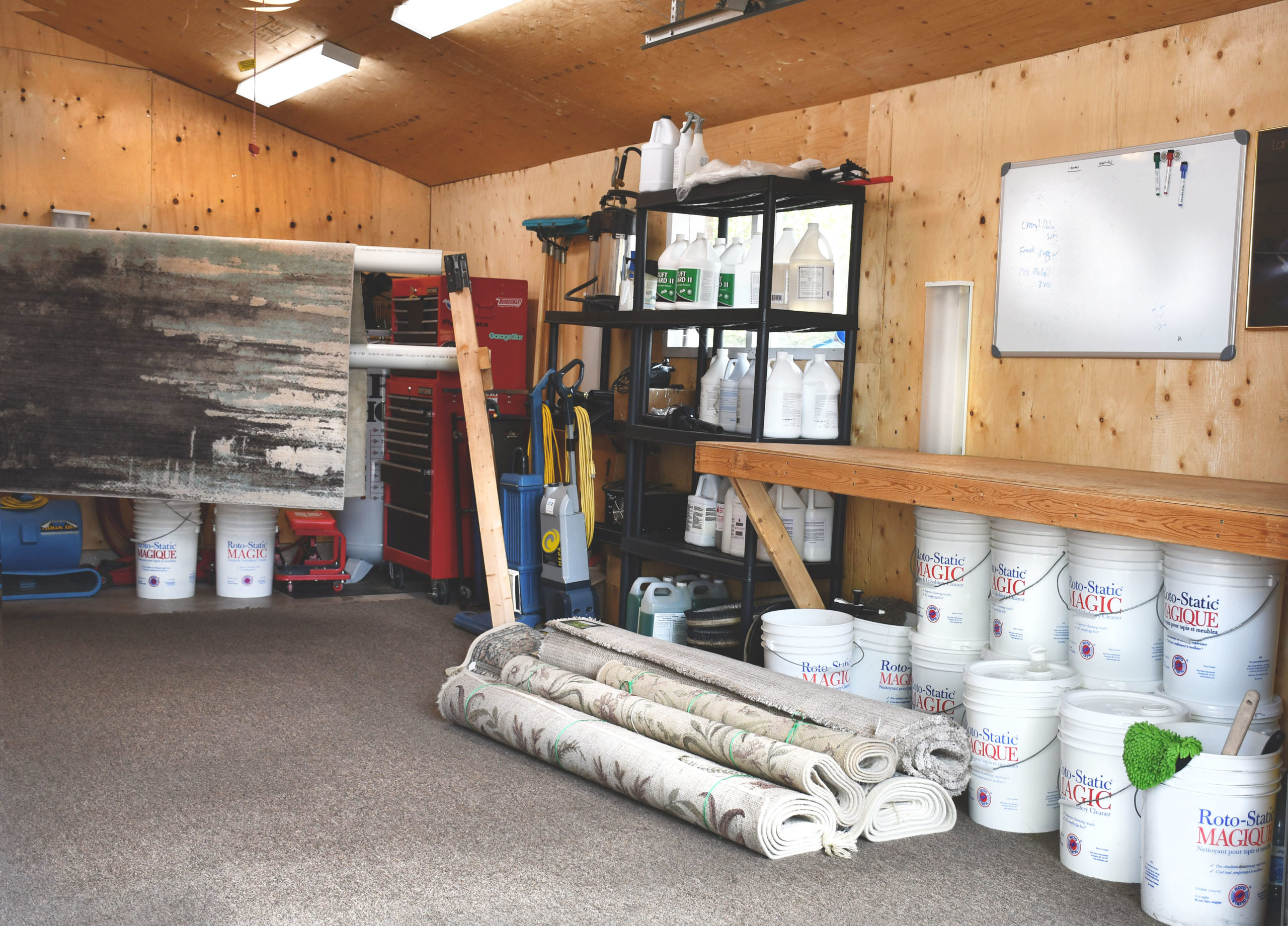 Rotostatic area rug shop filled with rugs, chemicals, and cleaning equipment